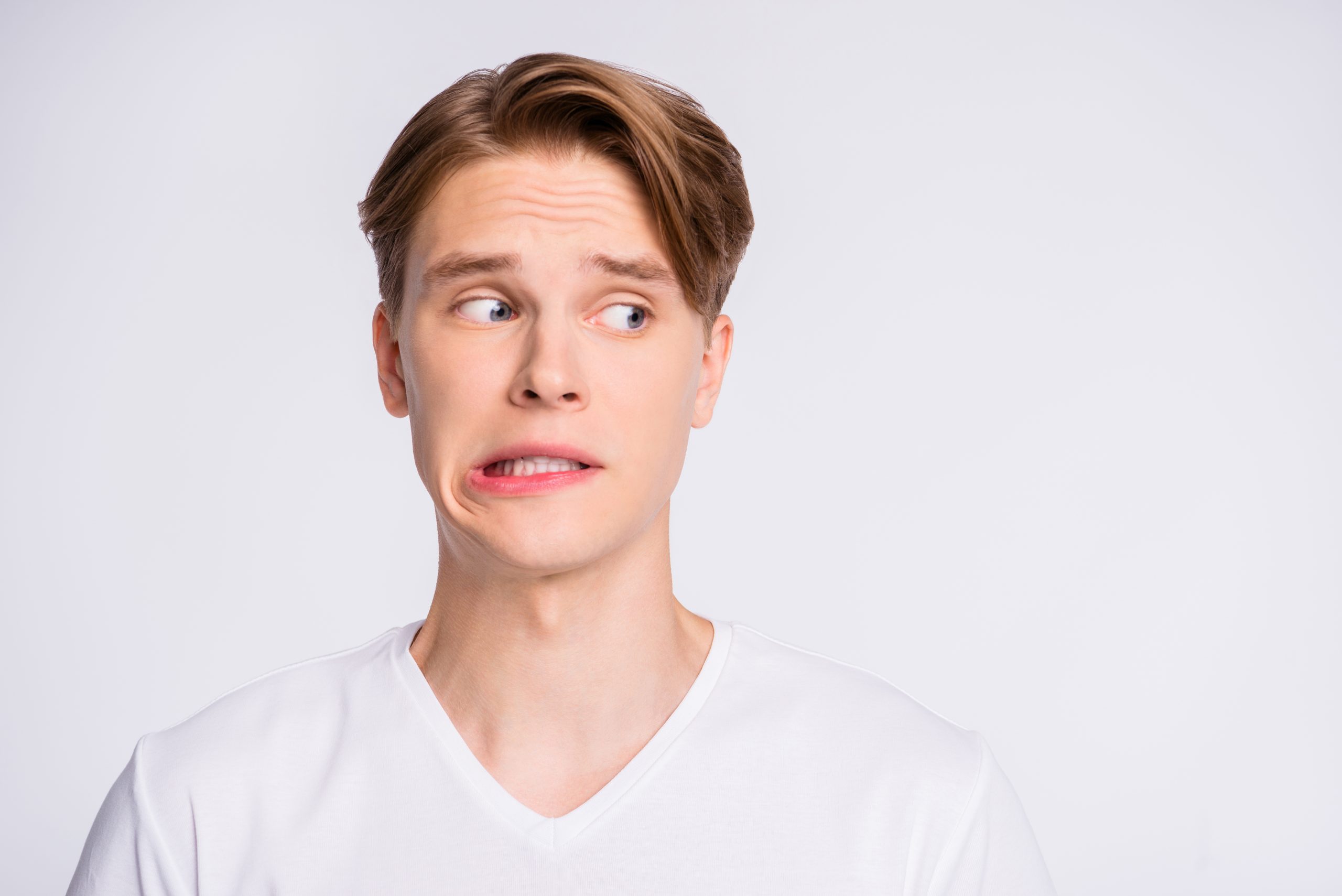 Close-up portrait of his he nice cute attractive worried uncertain guy looking, aside oops mistake fail isolated over light white pastel background