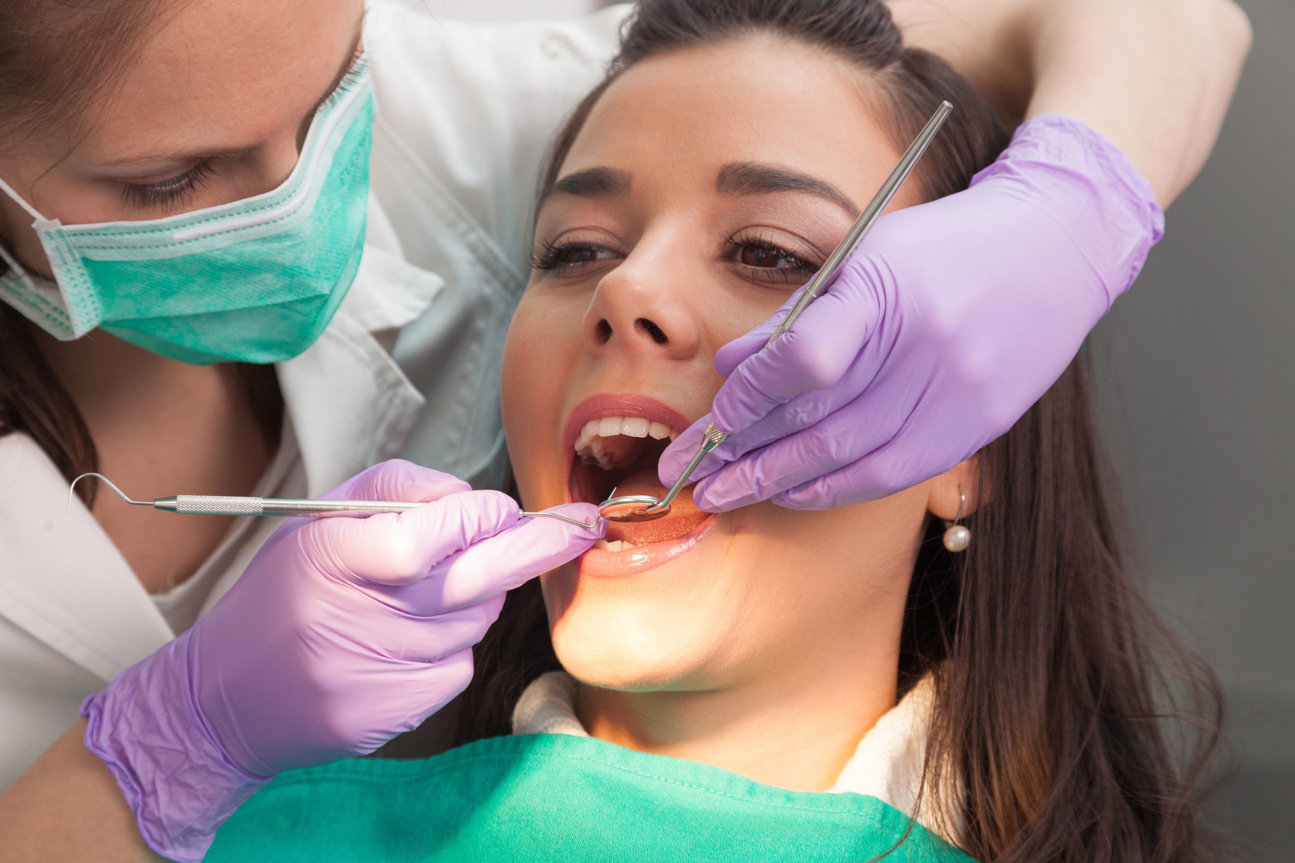 Overview of dental caries prevention.Woman at the dentist's chair during a dental procedure. Beautiful Woman smile close up. Healthy Smile. Beautiful Female Smile